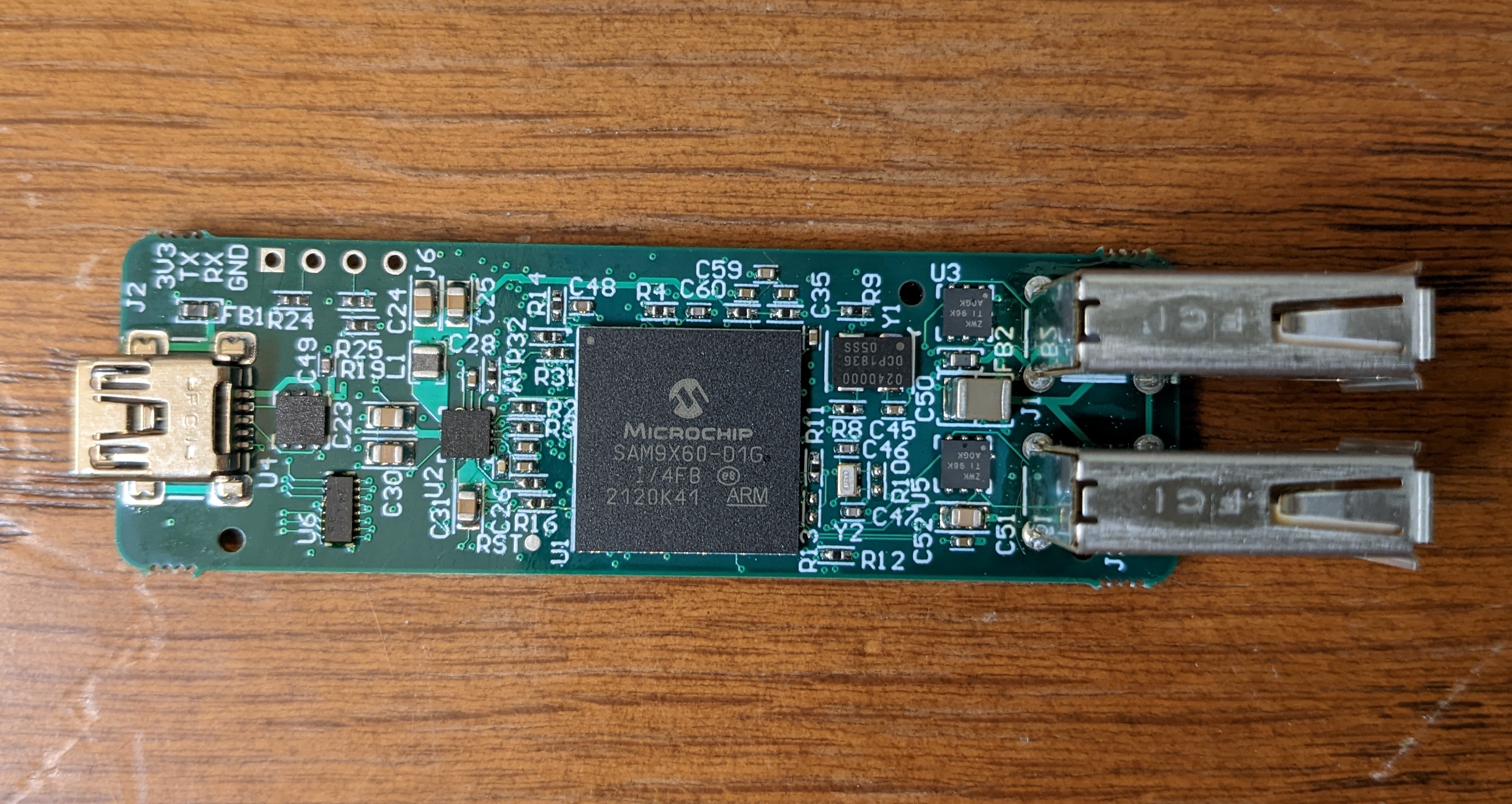 The board measures 67mm by 21mm, has a mini USB-B connector sticking out over one end and two vertical USB-A connectors on the other.